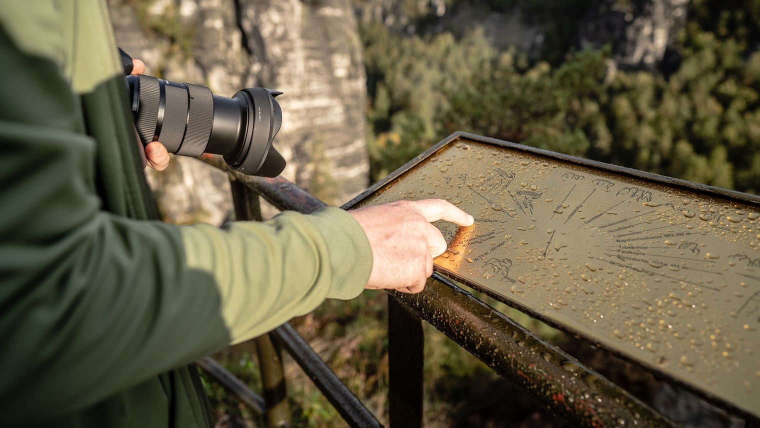 Ein Nationalparkführer zeigt auf eine schematische Karte im Nationalpark Sächsische Schweiz