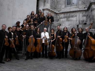 Musiker stehen mit ihren Instrumenten vor einem Gebäude