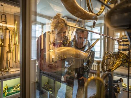 Ein Pärchen betrachtet Musikinstrumente in einer Vitrine im Musikinstrumentenmuseum in Markneukirchen.